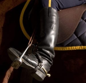 Mounted NYPD police office with closeup of black leather boot in stirrup